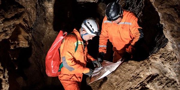 Two cavers looking at a map